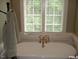 Bathroom with a freestanding tub and gold fixtures at 236 Olde Ferry Ln, Dunn, NC 28334