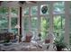 Bright sunroom with large windows overlooking the wooded area at 236 Olde Ferry Ln, Dunn, NC 28334