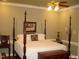 Bedroom with a four-poster bed and neutral color palette at 236 Olde Ferry Ln, Dunn, NC 28334