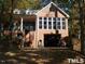 Brick home with a spiral staircase, large windows, and attached garage at 236 Olde Ferry Ln, Dunn, NC 28334