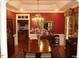 Elegant dining room with rich red walls and chandelier at 236 Olde Ferry Ln, Dunn, NC 28334