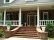 Brick home with a welcoming front porch, steps, and columns at 236 Olde Ferry Ln, Dunn, NC 28334