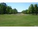 Spacious grassy lot with trees lining the perimeter at 236 Olde Ferry Ln, Dunn, NC 28334