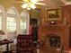 Cozy Gathering room featuring a brick fireplace and large windows at 236 Olde Ferry Ln, Dunn, NC 28334