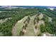 Aerial view of a golf course surrounded by lush greenery at 236 Olde Ferry Ln, Dunn, NC 28334