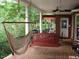 Relaxing porch with a hammock and wooden swing at 236 Olde Ferry Ln, Dunn, NC 28334