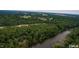 Aerial view of a property with a river and surrounding woods at 236 Olde Ferry Ln, Dunn, NC 28334