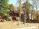 Brick house with large covered porch and surrounding trees at 236 Olde Ferry Ln, Dunn, NC 28334