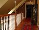 Upper hallway with hardwood floors and brick accent wall at 236 Olde Ferry Ln, Dunn, NC 28334