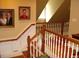Wooden staircase with classic balustrade and framed portraits at 236 Olde Ferry Ln, Dunn, NC 28334