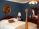 Elegant bedroom with a four-poster bed and antique furniture at 236 Olde Ferry Ln, Dunn, NC 28334