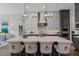 Modern kitchen featuring a large island, dark cabinetry, and high-end appliances at 62 Teal Trace Ct, Pittsboro, NC 27312