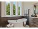 Spa-like bathroom featuring a freestanding tub and updated fixtures at 62 Teal Trace Ct, Pittsboro, NC 27312