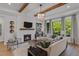 Bright living room featuring a fireplace, large windows, and comfortable seating at 62 Teal Trace Ct, Pittsboro, NC 27312