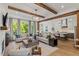 Open concept living space with exposed beams, fireplace and kitchen view at 62 Teal Trace Ct, Pittsboro, NC 27312