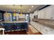 Modern kitchen featuring white cabinets, granite countertops, and a breakfast bar at 104 Abbeville Ln, Holly Springs, NC 27540