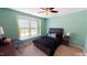Charming bedroom with a double bed, large window and ceiling fan at 104 Abbeville Ln, Holly Springs, NC 27540