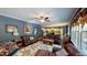 Spacious living room with hardwood floors, leather furniture, and a view into the kitchen at 104 Abbeville Ln, Holly Springs, NC 27540