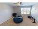 Comfortable bedroom with large window, ceiling fan, and a beanbag chair at 104 Abbeville Ln, Holly Springs, NC 27540