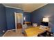 Home office with built-in desk and hardwood floors at 104 Abbeville Ln, Holly Springs, NC 27540