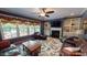 Open living room with fireplace, built-in shelving, and access to deck at 104 Abbeville Ln, Holly Springs, NC 27540