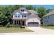 Two-story home with gray siding and a two-car garage at 104 Abbeville Ln, Holly Springs, NC 27540