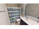 Clean bathroom with a shower/tub combo and striped shower curtain at 104 Abbeville Ln, Holly Springs, NC 27540
