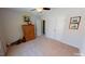 Well-lit bedroom with double doors to the closet and wood dresser at 104 Abbeville Ln, Holly Springs, NC 27540
