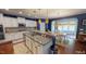 Kitchen with large island, granite countertops, and stainless steel appliances at 104 Abbeville Ln, Holly Springs, NC 27540