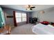 Spacious bedroom with hardwood floors, large window, and ceiling fan at 104 Abbeville Ln, Holly Springs, NC 27540