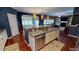 Open kitchen with island, stainless steel appliances, and breakfast nook at 104 Abbeville Ln, Holly Springs, NC 27540