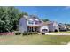 Two story house with gray siding and landscaping at 104 Abbeville Ln, Holly Springs, NC 27540