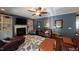 Cozy living room with built-in shelving, a fireplace, and hardwood floors at 104 Abbeville Ln, Holly Springs, NC 27540