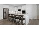 Modern kitchen with white cabinets, large island, and stainless steel appliances at 449 Winding Creek Dr, Lillington, NC 27546