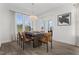 Bright dining room with wood table and leather chairs, overlooking backyard at 449 Winding Creek Dr, Lillington, NC 27546