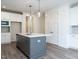 Kitchen features a large island with white quartz countertops at 1717 Grassy Falls Ln, Wendell, NC 27591