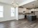 Modern kitchen with white cabinets, quartz countertops, and an island at 1717 Grassy Falls Ln, Wendell, NC 27591