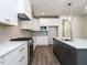 Bright kitchen with white cabinets and gray backsplash at 1717 Grassy Falls Ln, Wendell, NC 27591