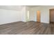 Large bedroom with wood flooring, multiple doors, and access to bathroom at 1717 Grassy Falls Ln, Wendell, NC 27591