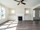 Living room with hardwood floors, fireplace, and built-in shelving at 1717 Grassy Falls Ln, Wendell, NC 27591