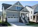 Gray house with white garage door and stone accents at 1717 Grassy Falls Ln, Wendell, NC 27591