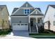 Gray house with white garage door and stone accents at 1717 Grassy Falls Ln, Wendell, NC 27591