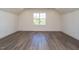 Bright bedroom featuring wood-look floors and a large window at 1717 Grassy Falls Ln, Wendell, NC 27591