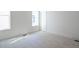 Well-lit bedroom with plush carpeting and a window at 1717 Grassy Falls Ln, Wendell, NC 27591