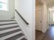 Staircase and hallway with dark hardwood floors at 1717 Grassy Falls Ln, Wendell, NC 27591