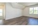 Spacious bedroom with wood-look flooring and large window at 1717 Grassy Falls Ln, Wendell, NC 27591