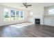 Sunlit living room with hardwood floors, fireplace, and built-in shelving at 1717 Grassy Falls Ln, Wendell, NC 27591