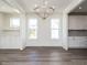 Elegant dining room with hardwood floors, chandelier, and built-in cabinetry at 1717 Grassy Falls Ln, Wendell, NC 27591