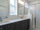 Modern bathroom with double vanity and walk-in shower at 1717 Grassy Falls Ln, Wendell, NC 27591