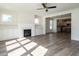 Open living room with hardwood floors, fireplace, and kitchen view at 1717 Grassy Falls Ln, Wendell, NC 27591